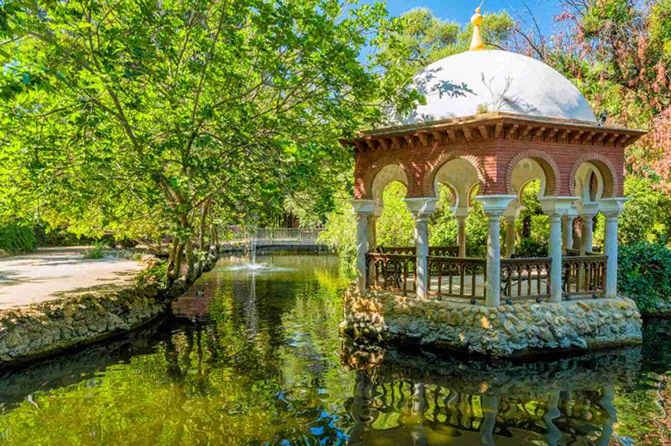 A gazebo in the middle of a pond in a park.