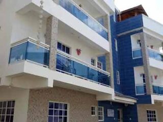 A blue and white apartment building with balconies and balconies.