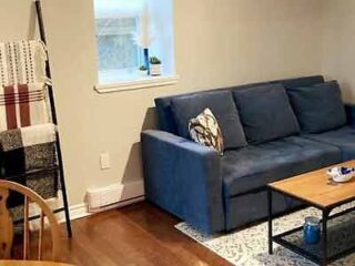 A living room with a blue couch and a coffee table.