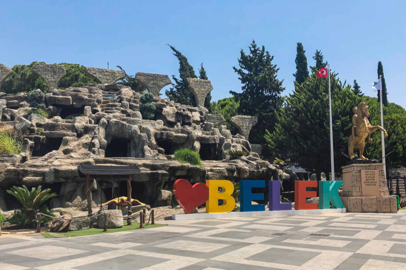A statue of the word belek in front of a park.