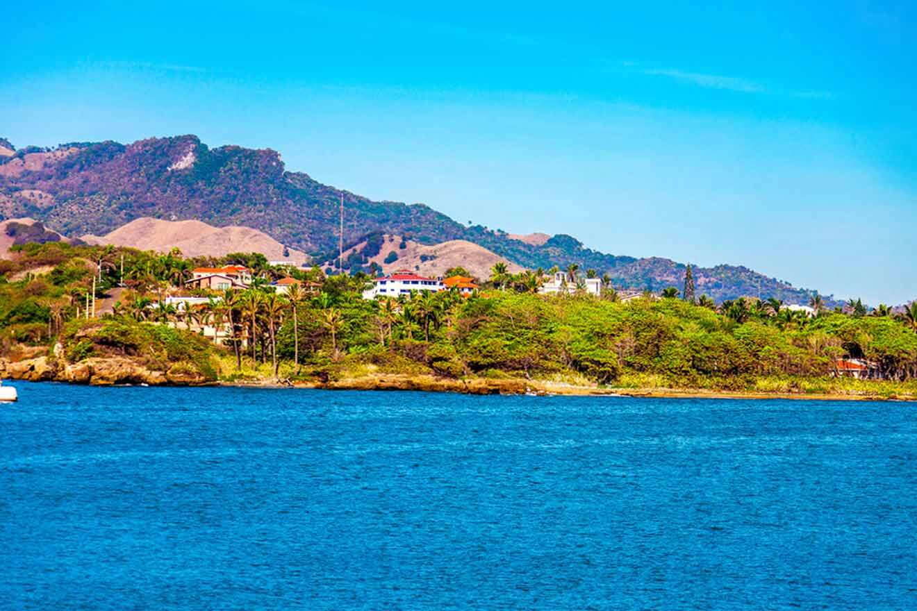 A boat on the water with mountains in the background.