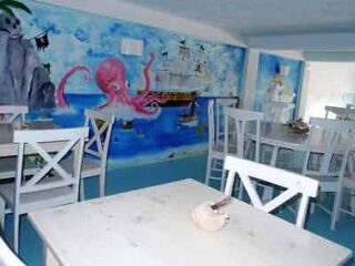 A restaurant with a mural of an octopus on the wall.