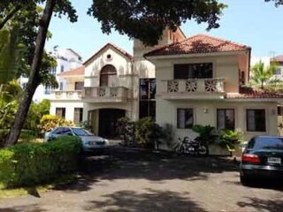 A house with cars parked in front of it.