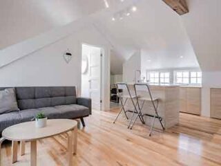 A living room with hardwood floors and a couch.