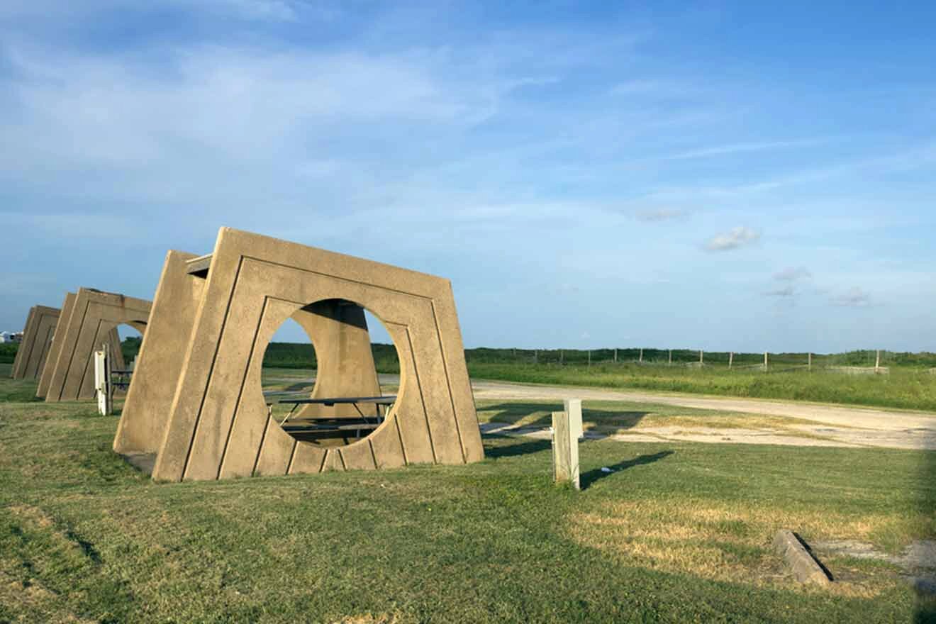 A wooden bench in the middle of a grassy field.