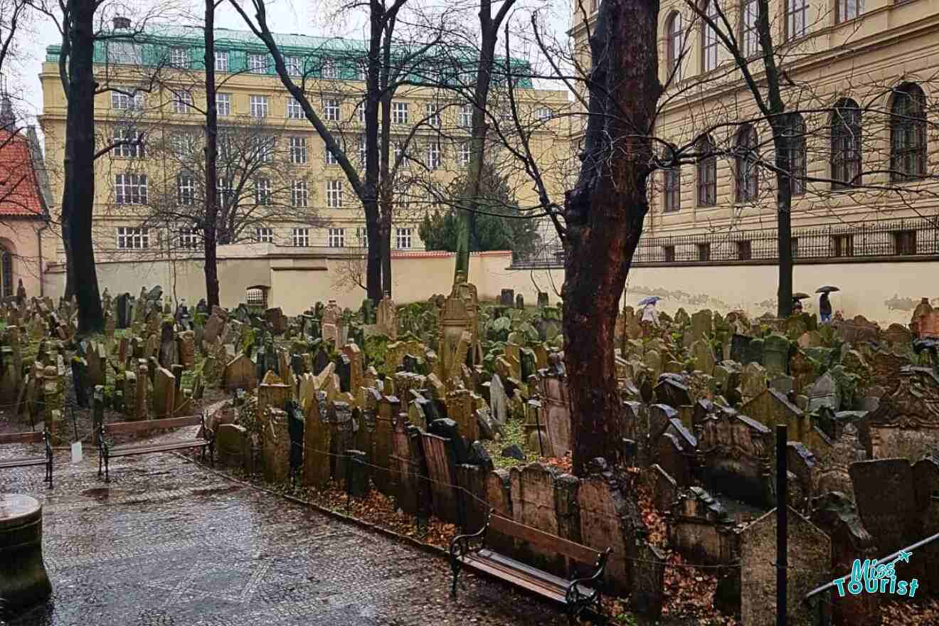 A cemetery with many tombstones in the rain.