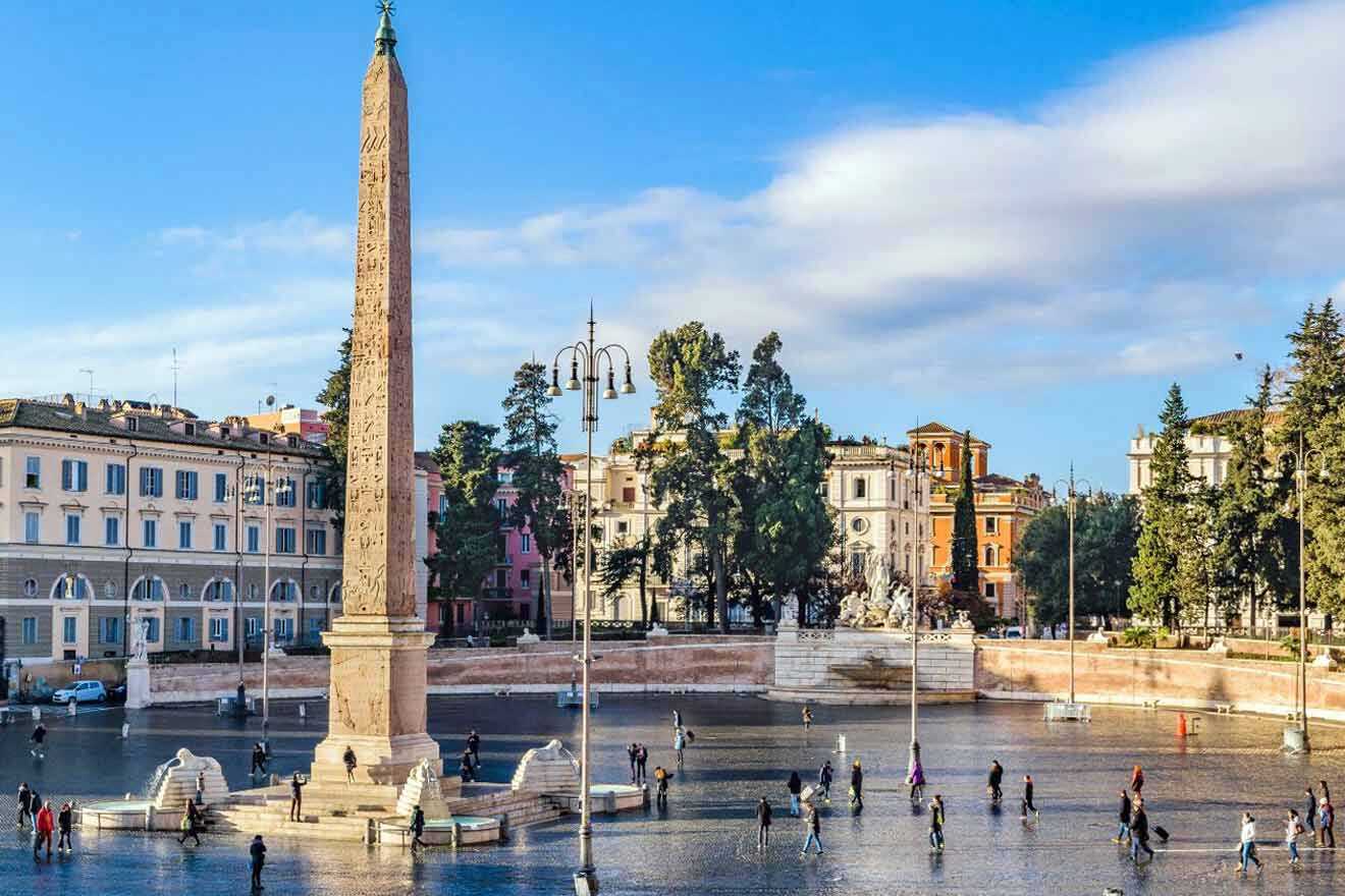 The towering obelisk of Piazza del Popolo with people walking around the plaza on a sunny day.