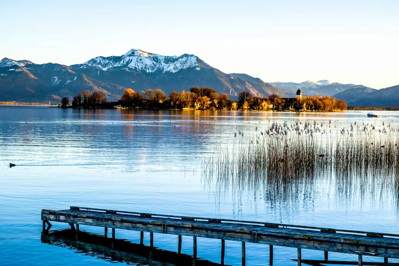 A dock on a lake with mountains in the background.