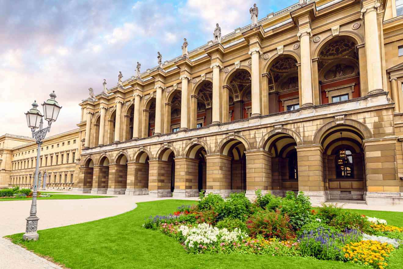 An ornate building with a lawn in front of it.