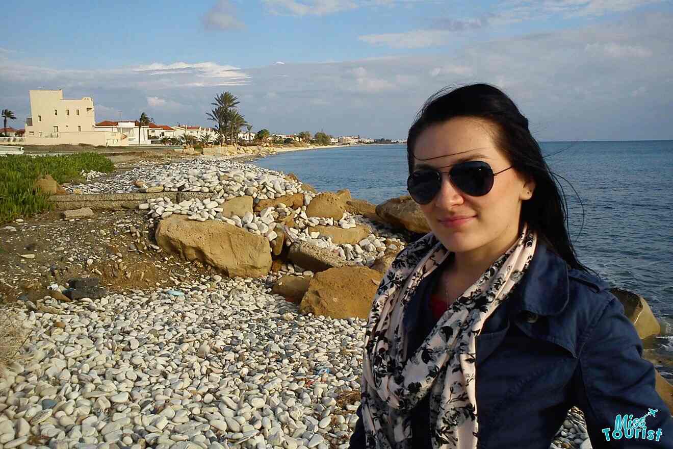 Kinga, the author of this post is standing on a beach with rocks
