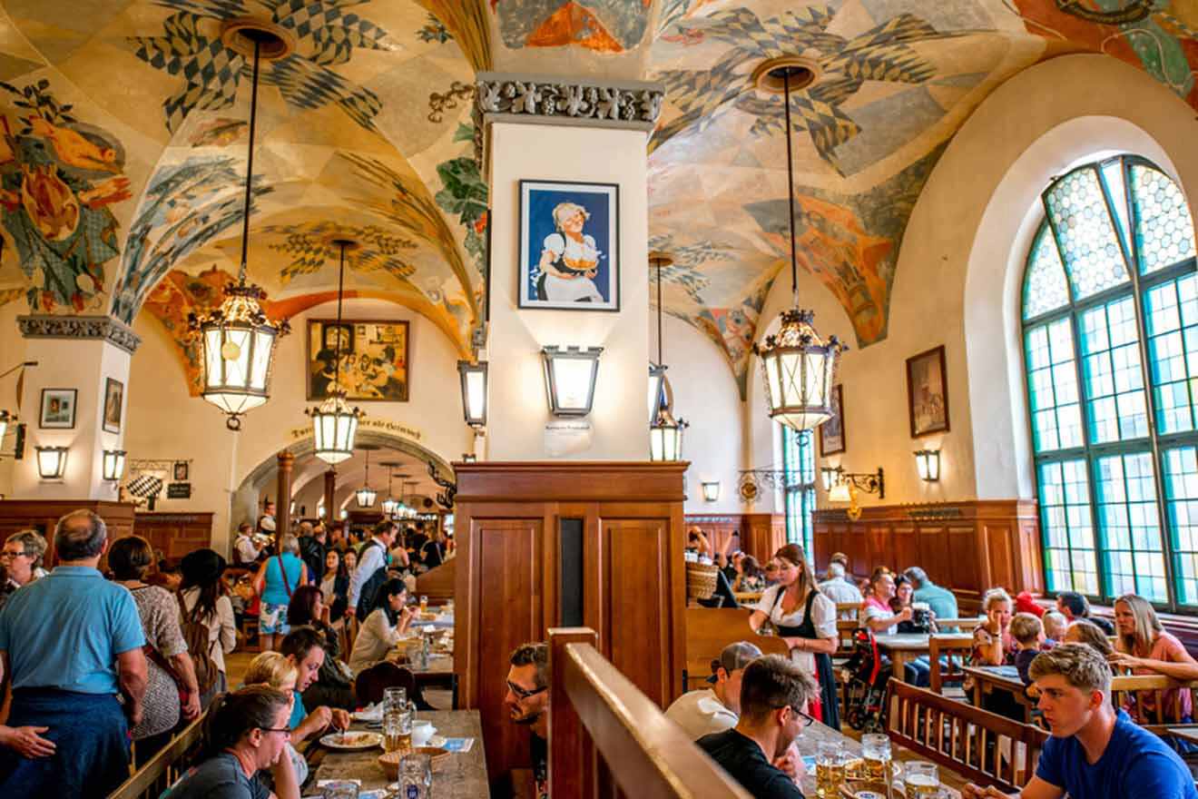 The interior of a restaurant with paintings on the walls.