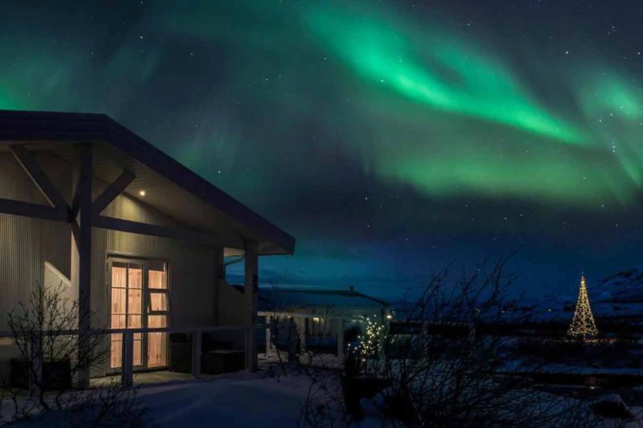The aurora borealis over a house in iceland.