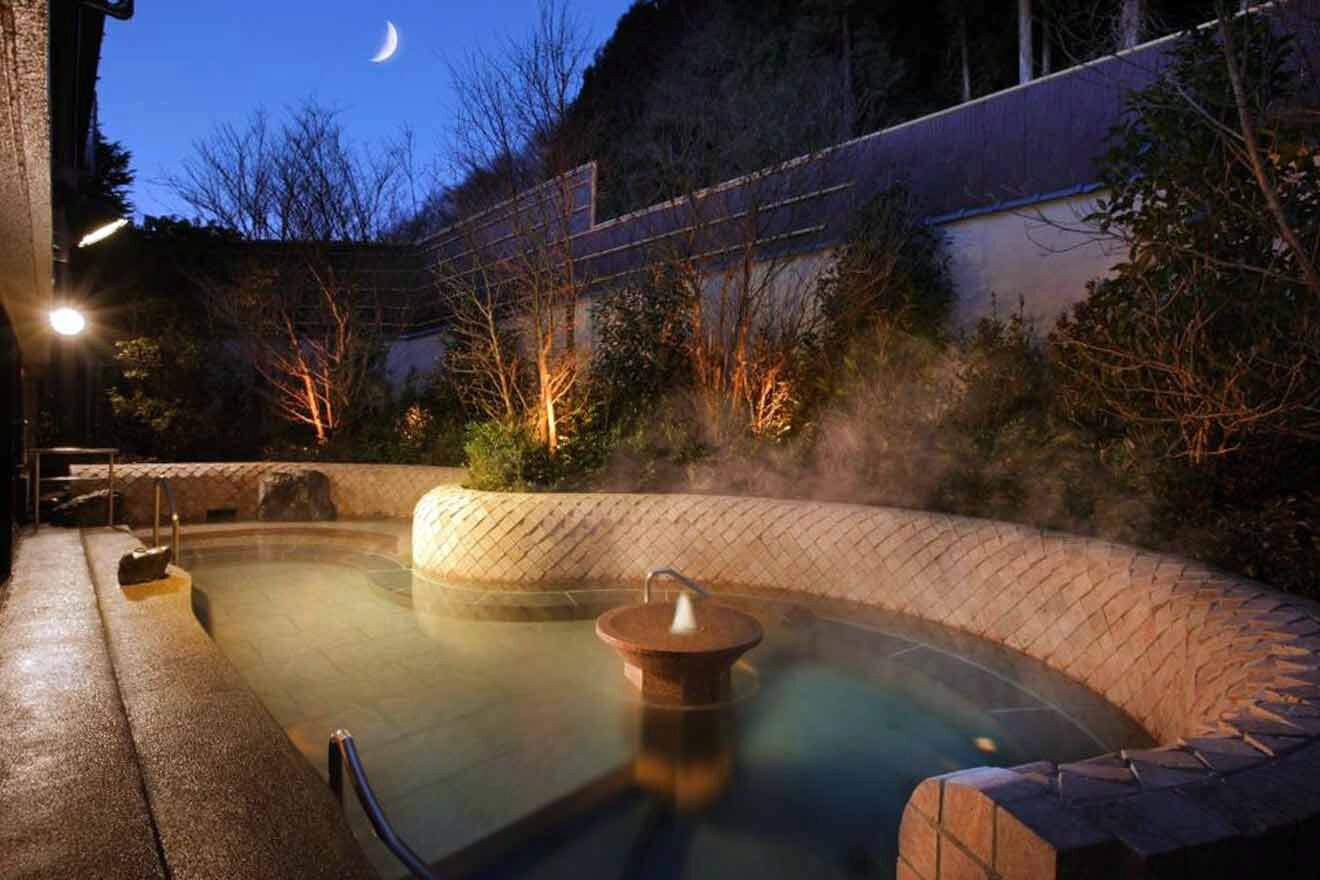 A hot tub in a garden at night.