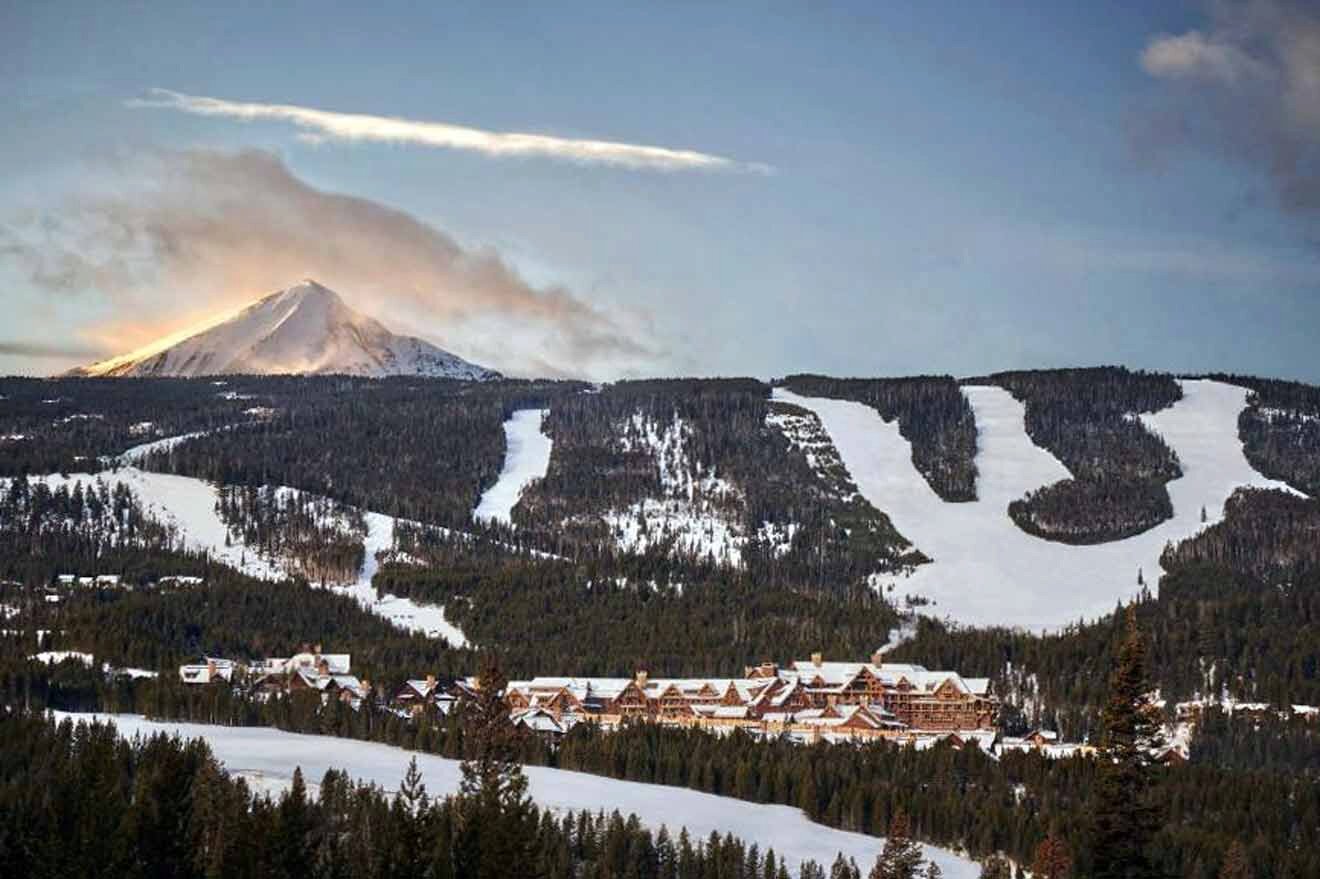 A ski resort with a mountain in the background.