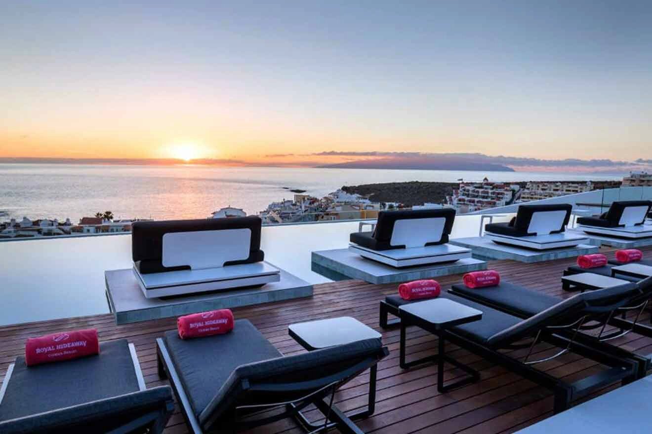 A rooftop pool with lounge chairs and a view of the ocean.