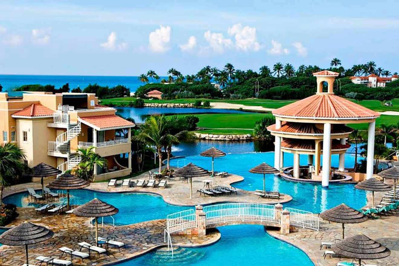 An aerial view of a resort with a pool and lounge chairs.