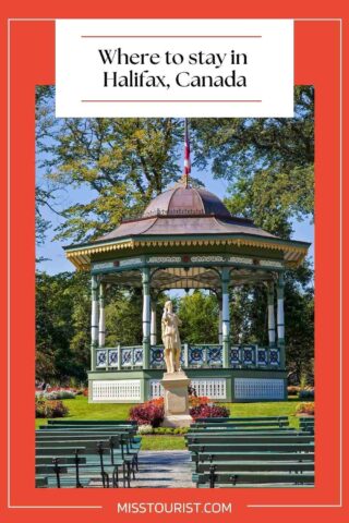 gazebo and a statue in a park with wooden benches in front of it