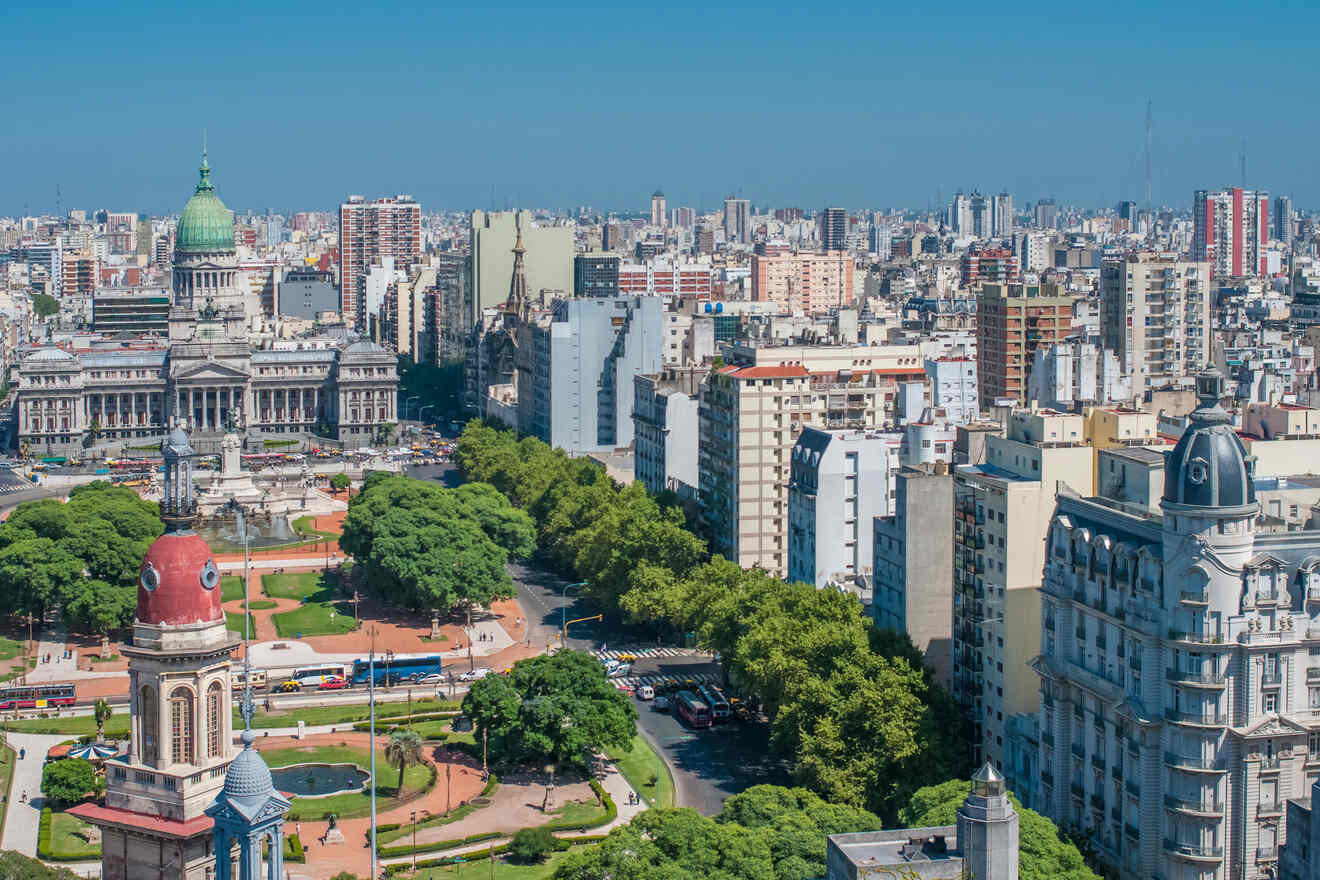 A clear daytime shot capturing the architectural beauty and green spaces of Buenos Aires, including the majestic Congress building and the lush Plaza Congreso in the foreground.