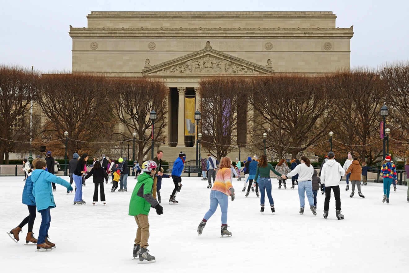 people skating on an ice rink during the day