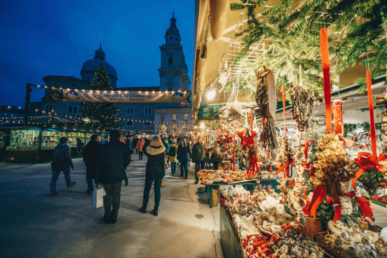 A christmas market in a city at night.