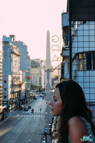 a girl overlooking a city street