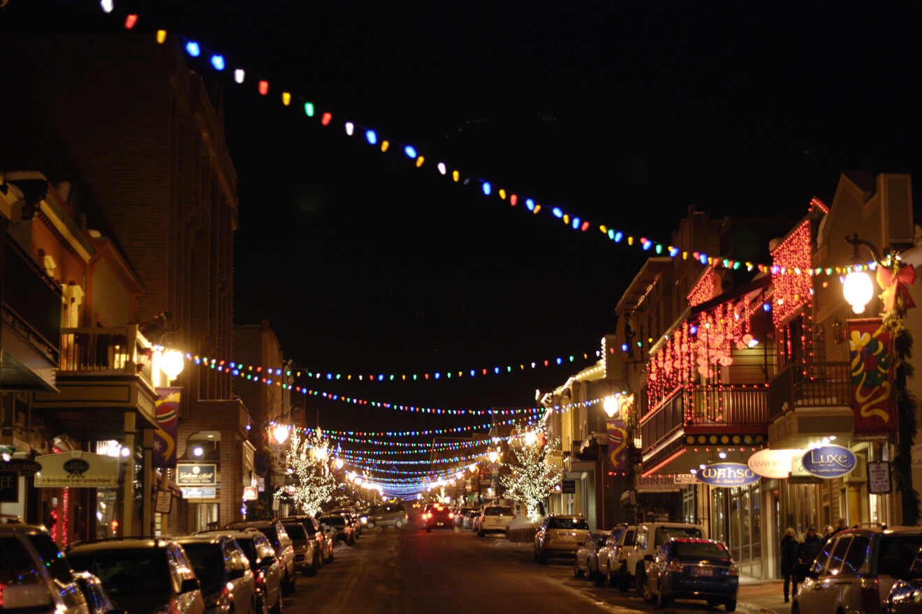 a town street decorated with Christmas lights