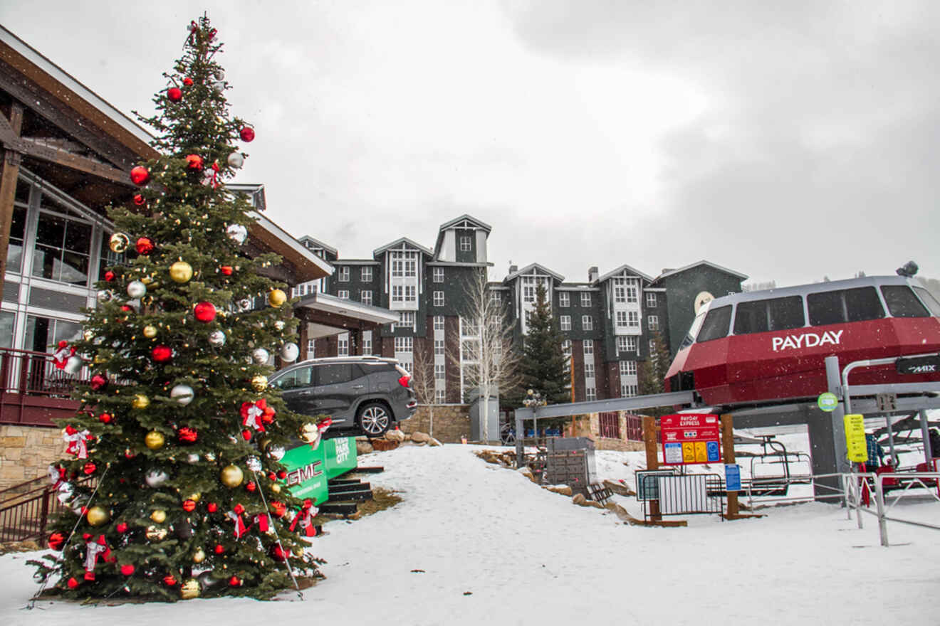 A ski lift with a christmas tree in front of it.