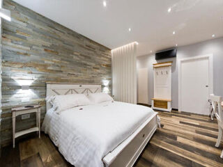 A bedroom with wooden floors and wooden walls.