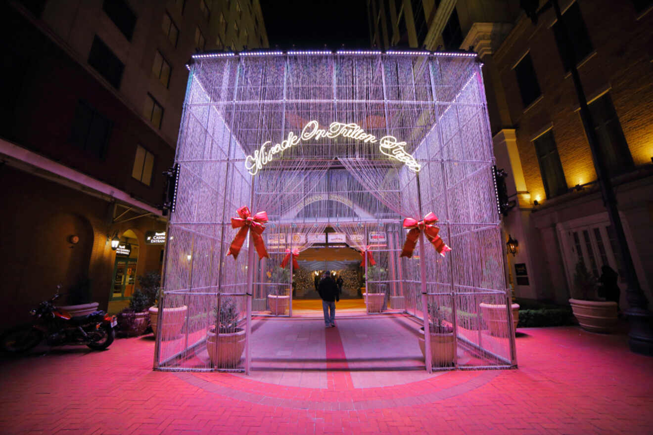 A person walks through a caged entrance to a hotel.