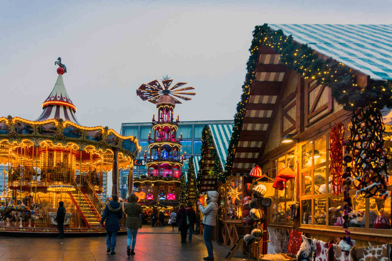 a carousel and other rides at a Christmas market