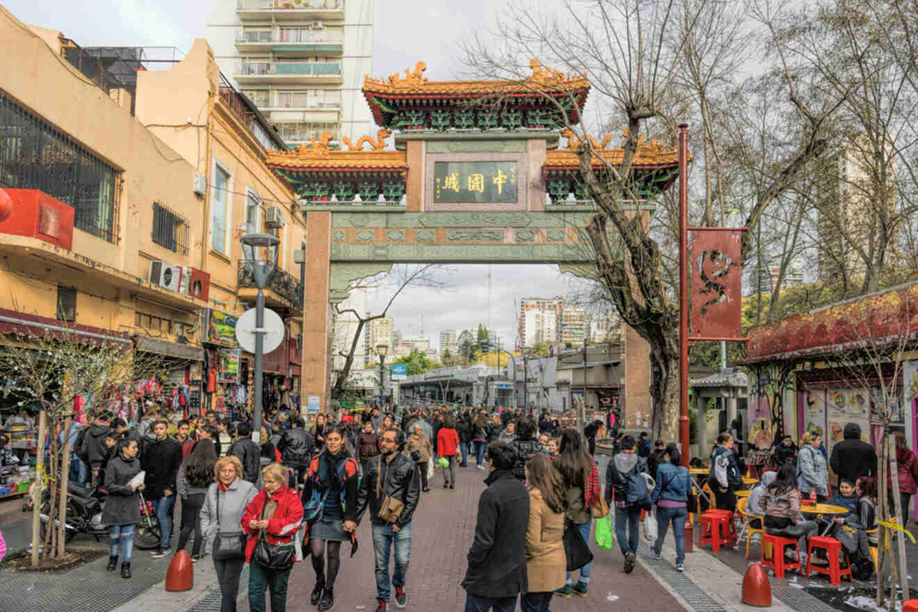 people walking through a Chinese gate