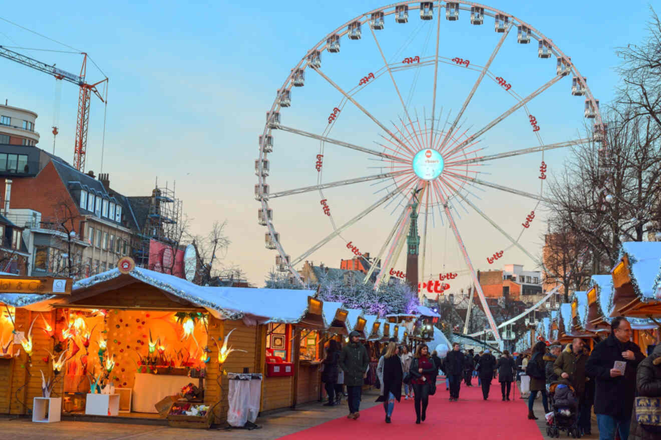 wooden Christmas market stalls with a Ferris wheel in the background