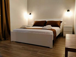 A bed or beds in a room with wooden floors.