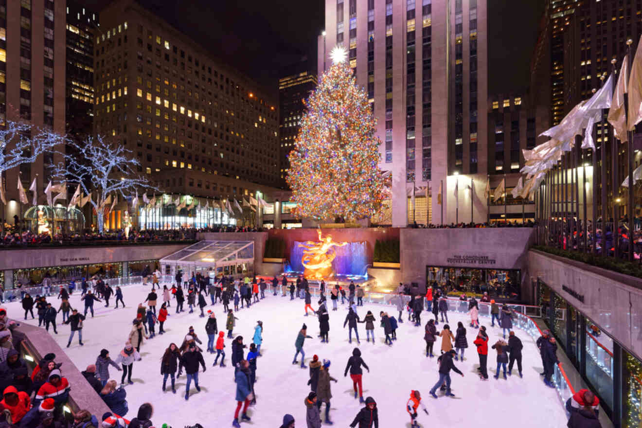 People skating on an ice rink in front of a giant Christmas tree