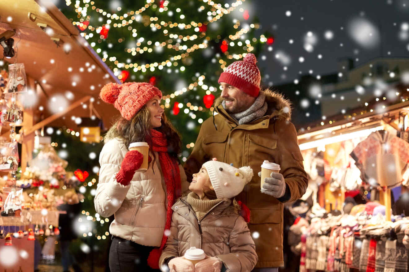 a family drinking hot beverages at a Christmas market