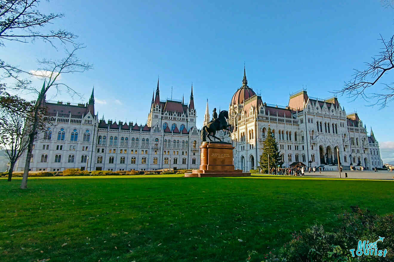 The Hungarian parliament building in Budapest with a statue of a man on a horse in front of it