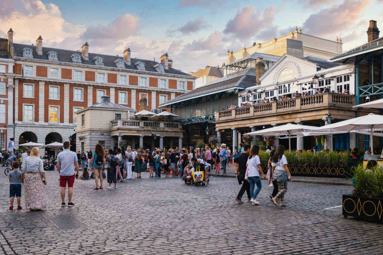 Crowds of visitors enjoying the vibrant atmosphere of Covent Garden with its classical architecture and outdoor dining areas
