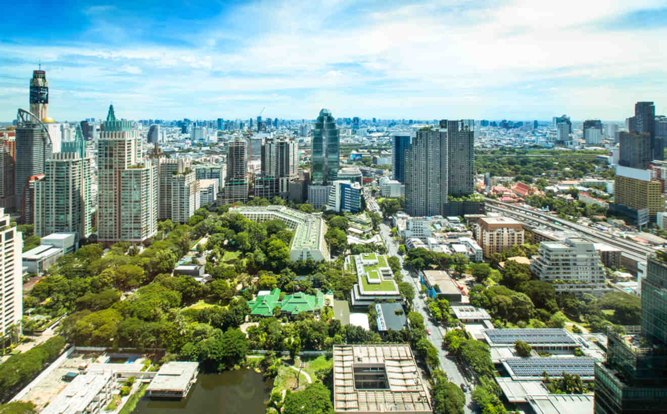 Aerial view of Bangkok's Sukhumvit district showcasing the blend of lush green spaces and dense urban high-rise buildings