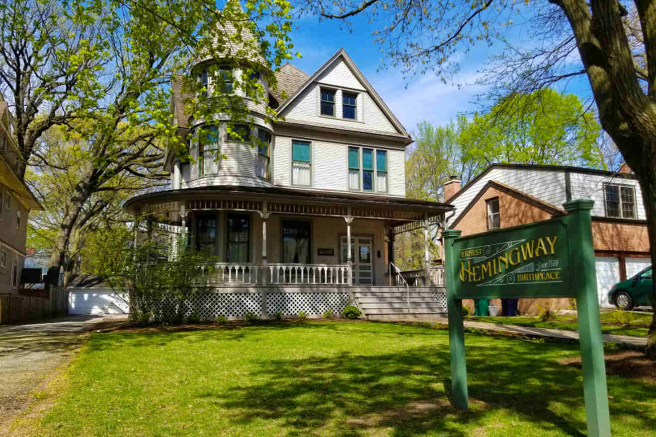 The Ernest Hemingway Birthplace Museum in Oak Park, Chicago, with its classic Victorian architecture and surrounding greenery, under a clear blue sky