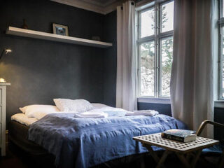 an apartment bedroom with blue sheets