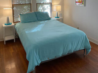 a bedroom with blue bedding