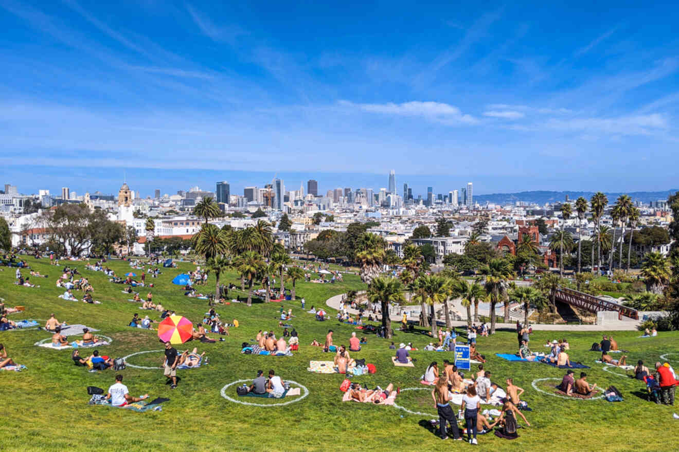 A vibrant scene at San Francisco's Mission Dolores Park, where locals enjoy a sunny day on the grass with the city's skyline stretching out in the distance.