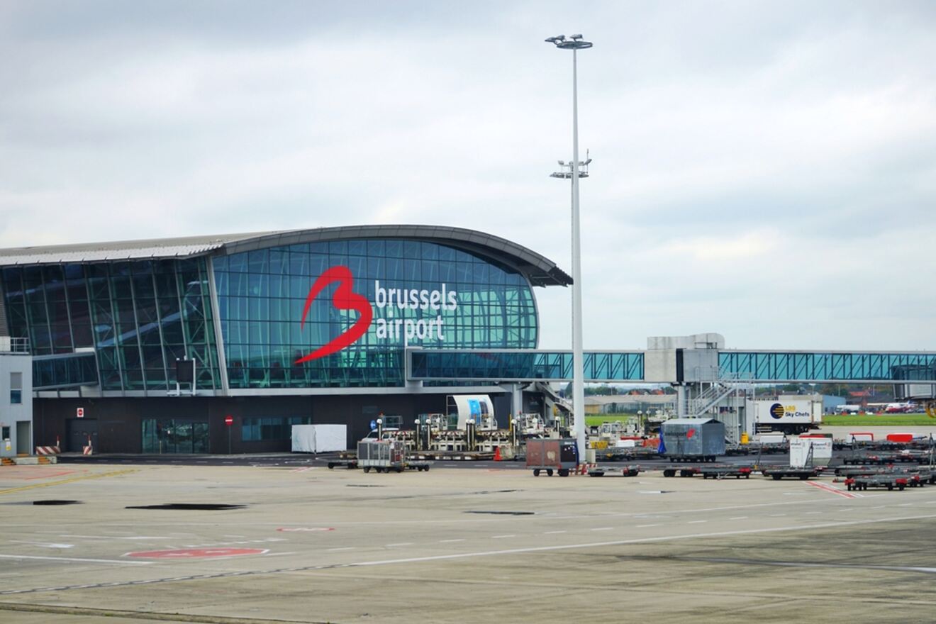 Brussels Airport terminal with its modern glass facade and the distinctive red logo