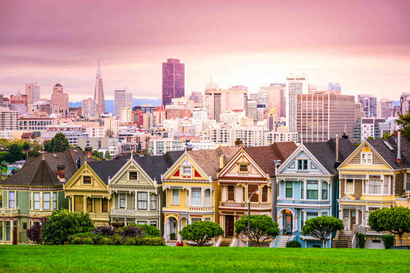 The iconic Painted Ladies of San Francisco, Victorian row houses with a backdrop of the city's skyline, under a surreal pink sunset sky.