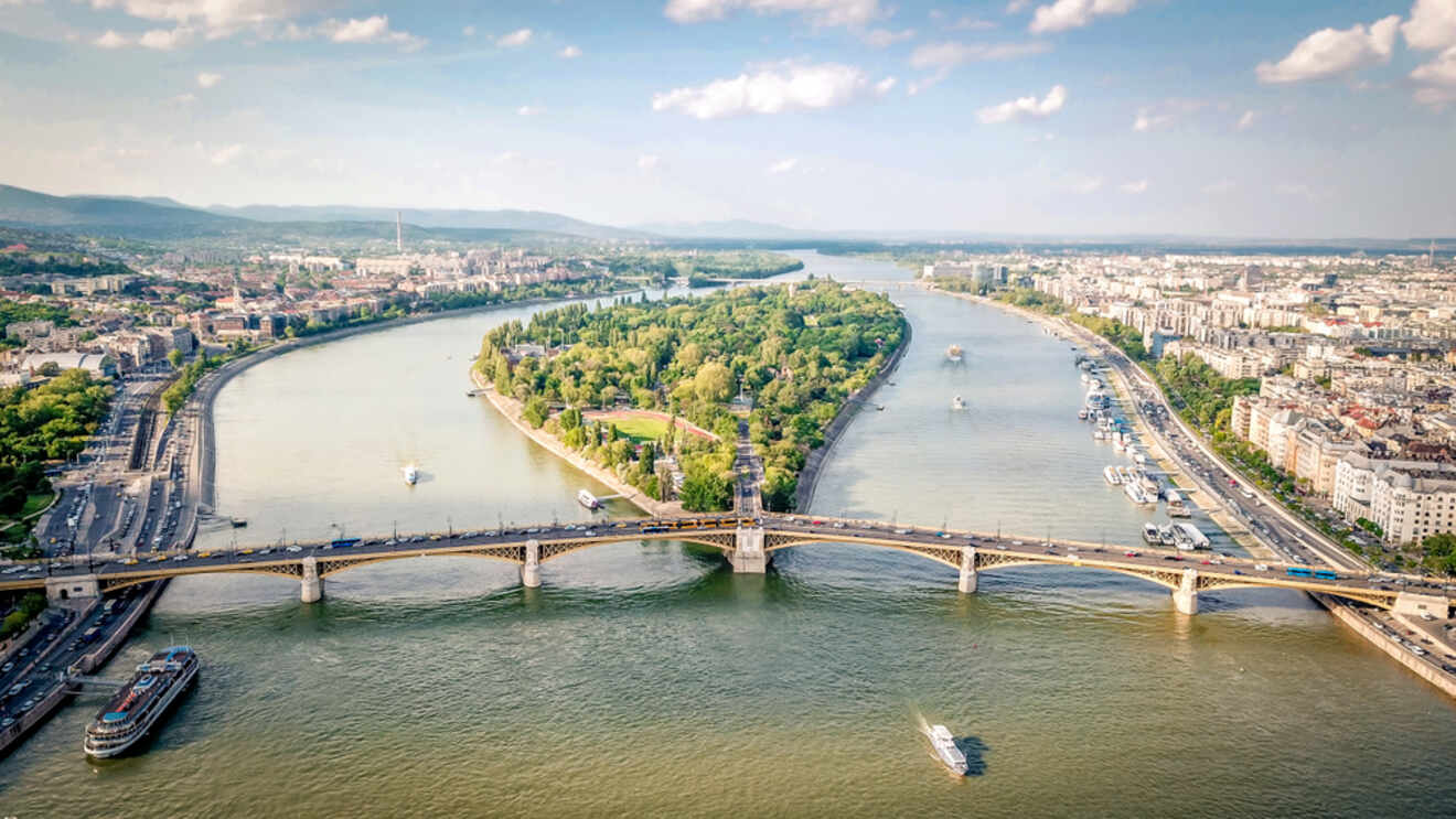 An aerial view of the Danube river in Budapest with Margaret Island sitting in the middle of the river