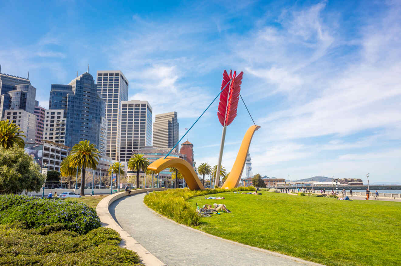A colorful art installation at Rincon Park in the Embarcadero district with San Francisco's skyline and blue skies in the background.