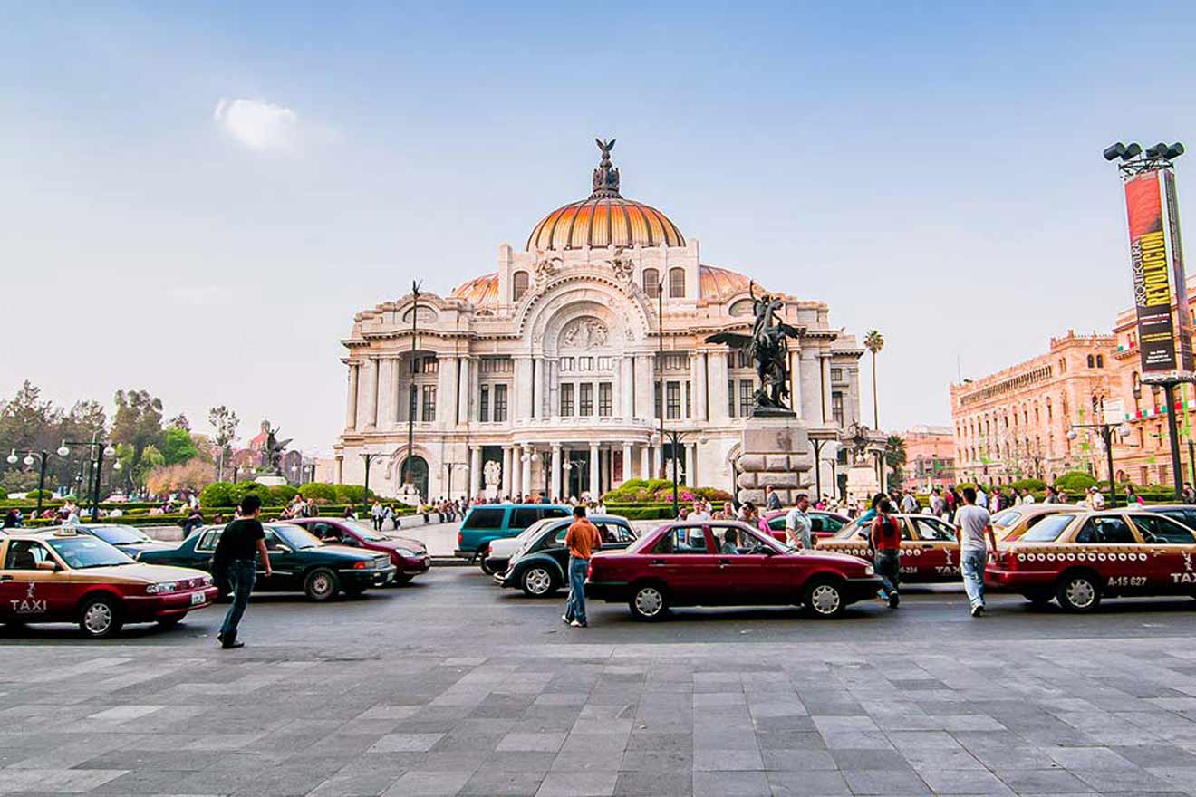 Traffic and pedestrians in front of palacio de bellas artes in mexico city at dusk.