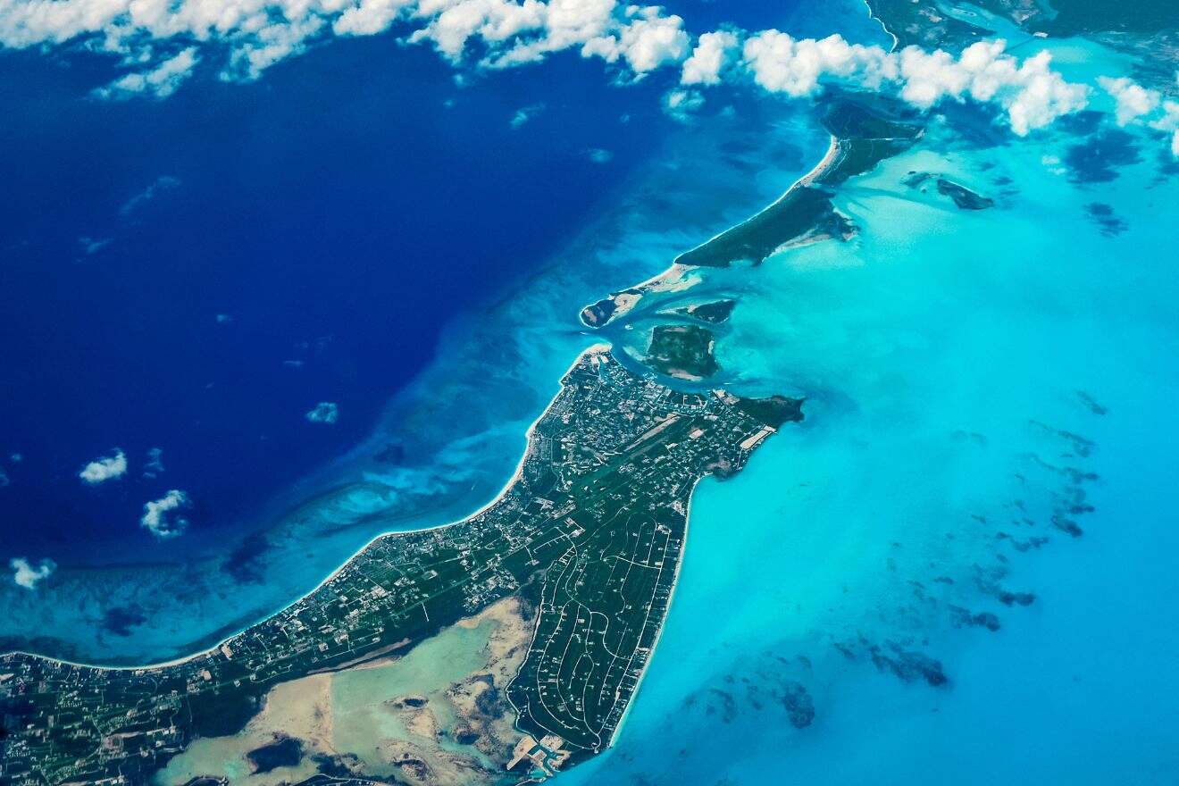 An aerial shot of Turks and Caicos, capturing the breathtaking blues of the ocean surrounding the land