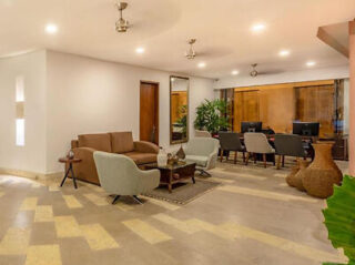 Well-appointed hotel lobby with plush seating, elegant decor, and a patterned floor