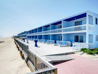 Montauk Blue Hotel exterior showcasing its vibrant blue and white façade with beachfront views